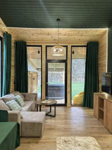 a living room with a couch and a table at Wolfmoon Riverside in Lupşa