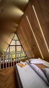 a bedroom with a bed in a tent at Wolfmoon Riverside in Lupşa +32 photos