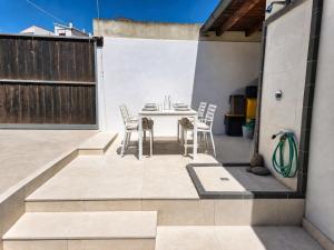 a patio with a table and chairs on a building at S'Archittu Sea Retreat in S'archittu Cuglieri
