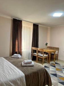 a bedroom with two beds and a table and a table at Studio Apartment Goris in Goris