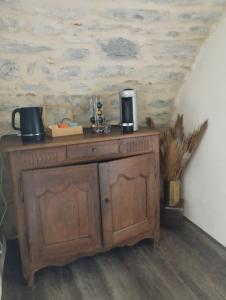 a wooden cabinet with a coffee maker on top of it at Iglesias Emmanuelle in Pradines