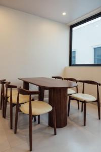 a table and chairs in a room with a window at Lavena Boutique Hotel in Sầm Sơn +57 photos
