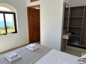 a bedroom with a bed with two towels on it at Aqua Marine in Falasarna +80 photos