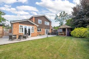a brick house with a yard and a gazebo at The Garden Studio in Wargrave