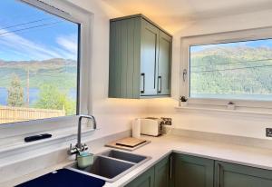 a kitchen with a sink and a window at Kilbride Lodge in Carrick