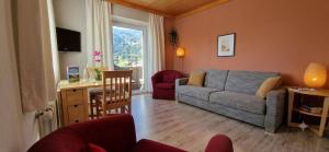 a living room with a couch and a table at Boutique73 Sunset in Altossiach +24 photos