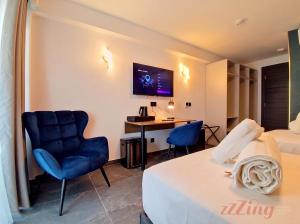 a hotel room with a bed and a desk and a tv at A Plus Hotel St Julians - Adults Only in St. Julianʼs