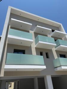 a building with glass balconies on the side at Olympus Hospitality Rhodes in Rhodes Town