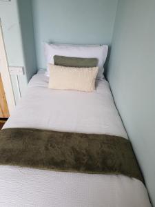 a bed with a brown and white comforter at Glenlara House in Youghal