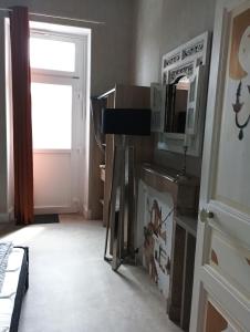 a room with a window and a door with boxes at Chambre pour 2, avec terrasse privée in Montgivray
