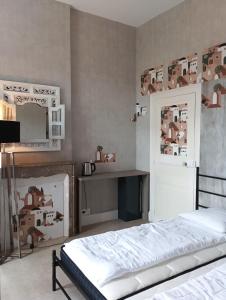 a bedroom with a bed and a desk with a mirror at Chambre pour 2, avec terrasse privée in Montgivray