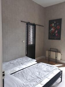 a bedroom with a bed in a room with a window at Chambre pour 2, avec terrasse privée in Montgivray
