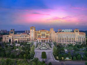 a large building with a fountain in front of it at Pullman Yueyang in Yueyang