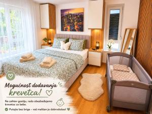 a bedroom with a bed with two towels on it at Panorama Gold in Soko Banja
