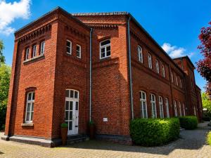 a large red brick building with white windows at Bad Oeynhausen - City, Küche, Netflix, Wifi, zentral, StudioApartment in Bad Oeynhausen
