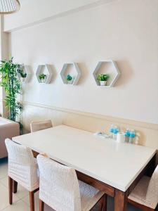 a white dining room with a white table and chairs at Mactan Newtown Condo Rental in Punta Engaño