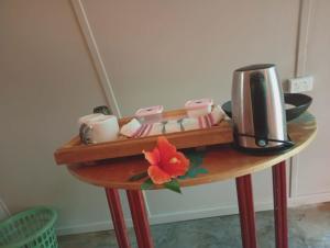a table with a coffee maker on top of it at Fortunate Lodge, Restaurant & Bar in Lénakel
