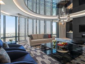 a living room with a couch and a table at Fairmont Riyadh in Riyadh