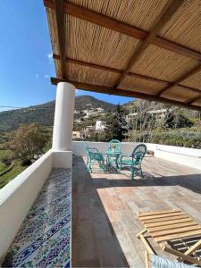 a patio with two chairs and a table on a roof at Melania Home in Filicudi +14 photos