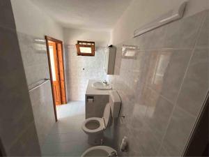 a bathroom with a toilet and a sink at Melania Home in Filicudi