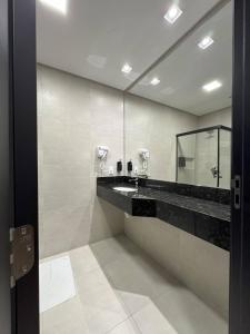 バウネアーリオ・コンボリウーにあるHotel das Américasの洗面台と鏡のある浴室