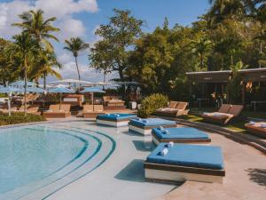 a resort pool with lounge chairs and a swimming pool at Fairmont El San Juan Hotel in San Juan