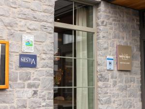 a glass door of a building with a sign on it at Mercure Han-sur-Lesse in Han-sur-Lesse