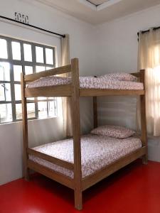 two bunk beds in a room with a window at Jules Place Arusha in Themi