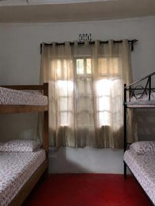 a bedroom with two bunk beds and a window at Jules Place Arusha in Themi