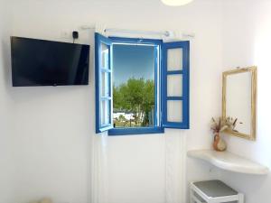 a bathroom with a blue window and a sink at Villa Solasta #2 with jacuzzi in Santorini in Akrotiri