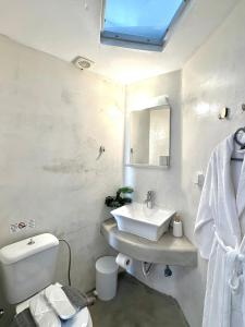 a white bathroom with a sink and a toilet at Villa Solasta #2 with jacuzzi in Santorini in Akrotiri +15 photos