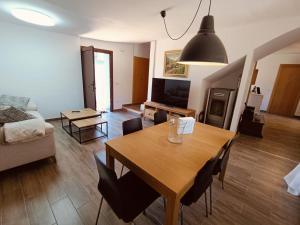 a living room with a table and a living room with a couch at Casa Remedios in Cubla