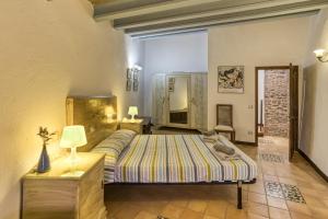 a bedroom with a bed and a table and a mirror at Casa Blava in Orriols