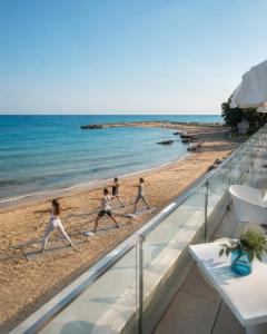 a group of children playing on the beach at HVD Nympha Hotel - All Inclusive, Private Beach & Free Parking - Adults Only in Golden Sands
