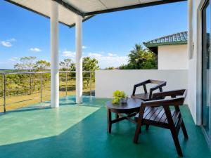 two chairs and a table on a porch with a view at Bundala Forest Resort Yala in Weerawila