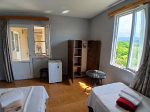 a room with two beds and a window at Nika Inn Kobuleti in Kobuleti