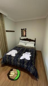 a bedroom with a bed with towels on it at Casa Ferrari in Santa Teresa