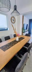 a dining room table with chairs and a vase with flowers at Beachfront Villa Sol&Mar with heated pool and jacuzzi in Kaštela +76 photos
