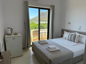 a bedroom with a bed with towels on top of it at Aqua Marine in Falasarna