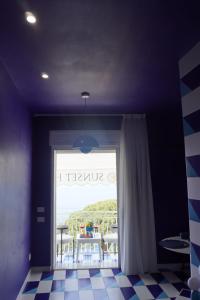 a room with a window with a view of the ocean at MIja Sunset home in Praiano +104 photos