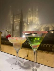 two cocktails sitting on a table in front of a window at Burgos Spa and Cathedral in Burgos +6 photos