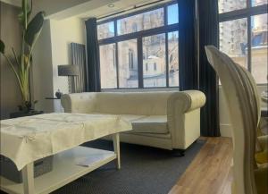 a living room with a couch and a window at Burgos Spa and Cathedral in Burgos