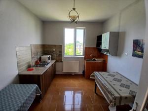 a room with a kitchen with a bed in it at Nika Inn Kobuleti in Kobuleti