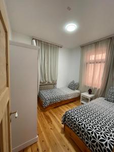 a bedroom with two beds and a window at Gasthaus Liam 1 in Bendorf-Sayn