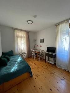 a bedroom with a bed and a table and a desk at Gasthaus Liam 1 in Bendorf-Sayn