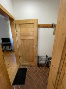 a wooden door in a room with a brick floor at Gasthaus Liam 1 in Bendorf-Sayn