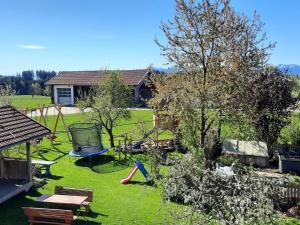 a backyard with a playground with a swing at Mojer-Hof in Taching am See