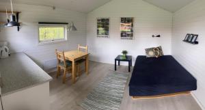 a room with a bed and a table in a tiny house at Vejle City Camping in Vejle