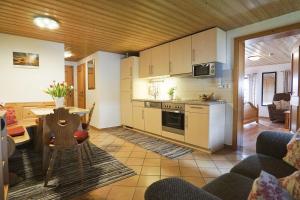 a kitchen and living room with a table and chairs at Mojer-Hof in Taching am See