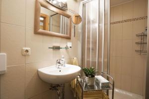 a bathroom with a sink and a shower at Mojer-Hof in Taching am See +16 photos